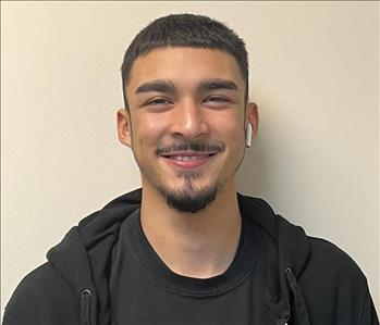 Man with black shirt and white back round